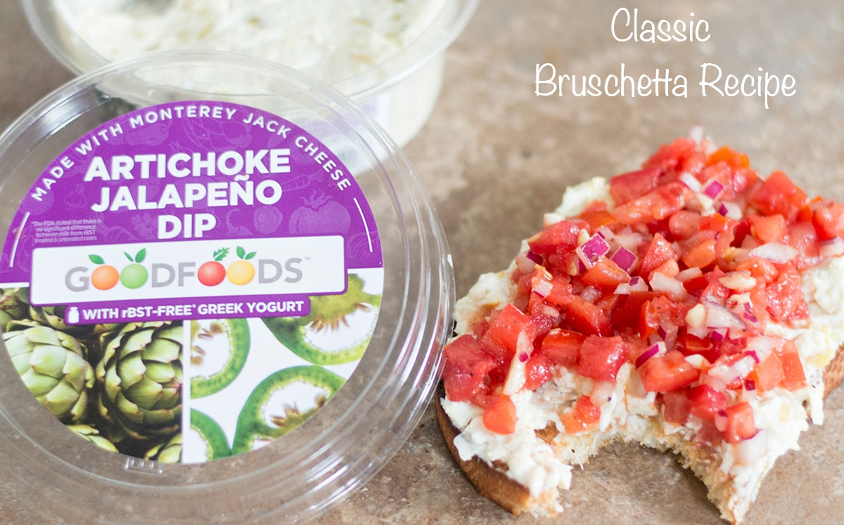 Overhead view of artichoke bruschetta and the GoodFoods artichoke dip next to it