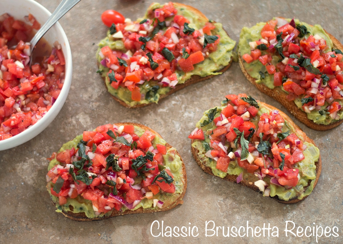 Overhead view of four gucamole bruschetta with a white bowl on the side filled with bruschetta