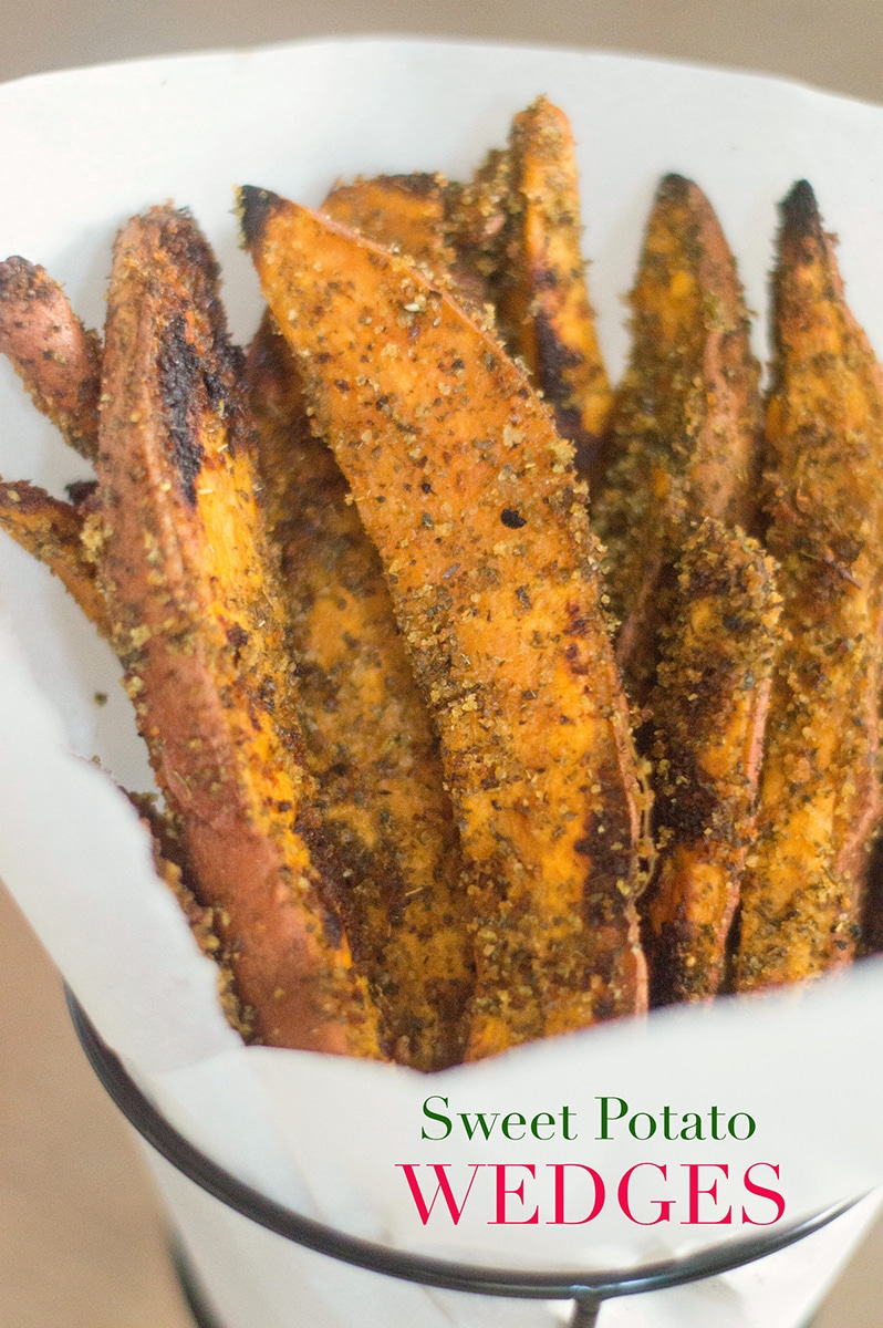 Landscape View of Sweet Potato Wedges Lined Upright In a Cone Made From Parchment Paper and Placed in a Cone-Shaped Black Fry Holder