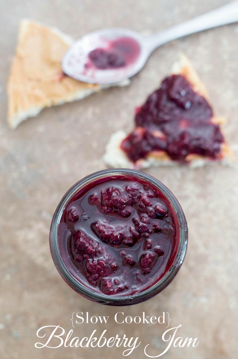 Overhead view of a small mason jar filled with blackberry jam.