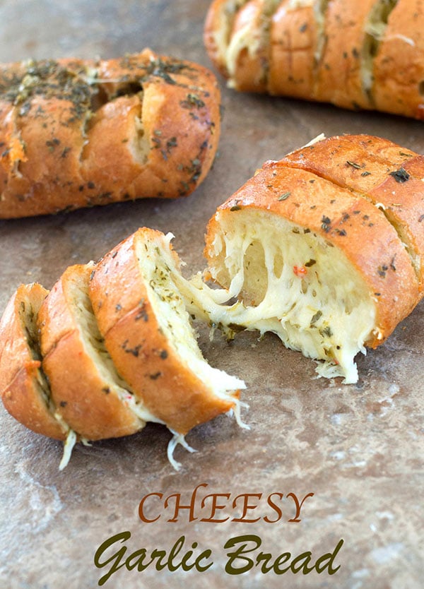 Front view of cooked cheesy garlic bread with streachy cheese visible