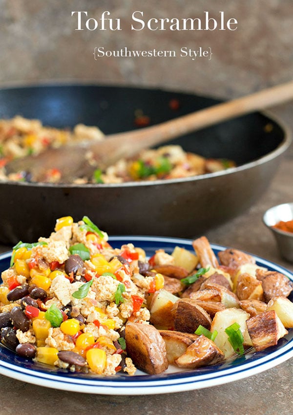 Front view of a plate with tofu scramble and a side of potatoes