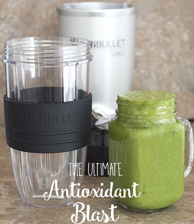 Front view of the nutribullet container next to a glass filled with the ultimate antioxidant blast. The Nutribullet Select base is in the background
