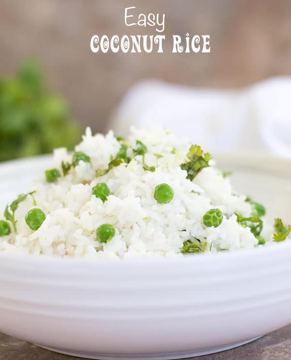 Front view of a white bowl with coconut rice and peas