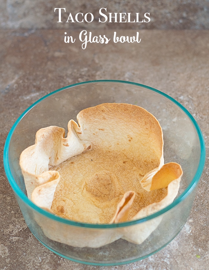 Overhead view of a tortilla bowl baked in a glass bowl - How to Make Taco Shells