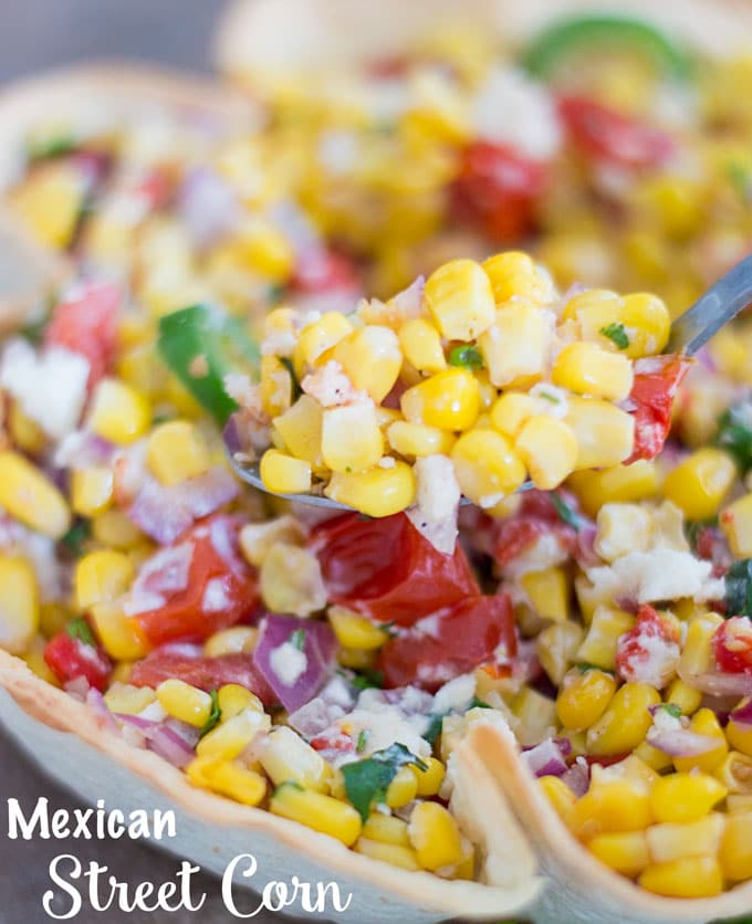 Closeup of Mexican Street Corn on a spoon with bowl below