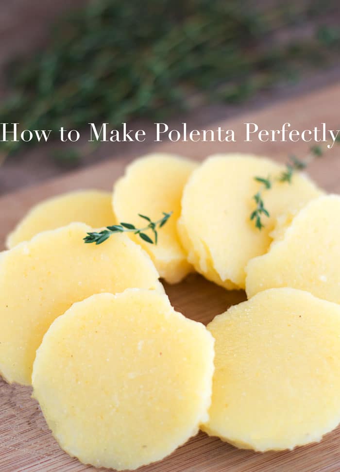 45° view of Polenta Rounds Arranged in a Circle are Laid on a Brown Chopping Board. Two Stray of Thyme Leaves Placed on the Polenta. A Few Sprigs of Thyme are Visible in the Background