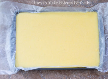 Overhead View of a Baking Tray Lined With Parchment Paper and Filled With Cooked Polenta