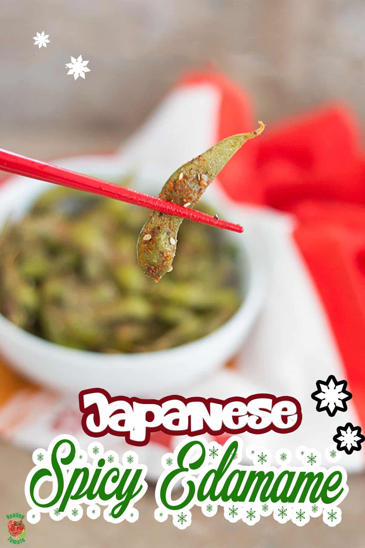 Front view of a pair of chopsticks holding one piece of edamame pod