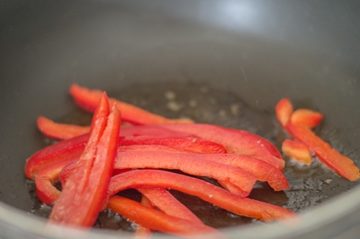 Red Bell Pepper Strips in Stir Fry Pan