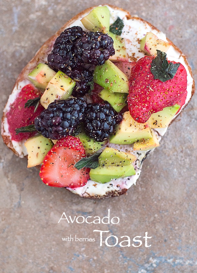 Overhead View of A Toasted Slice of Bread with Vegan Cream Cheese Spread and Topped with Avocado, Fresh Strawberries and Blackberries