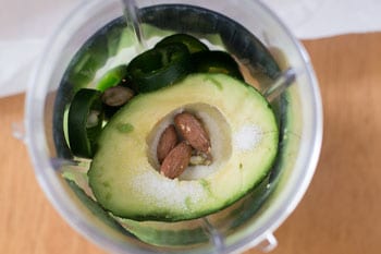 Overhead View of avocado + nuts + salt in Blender - Avocado Soup