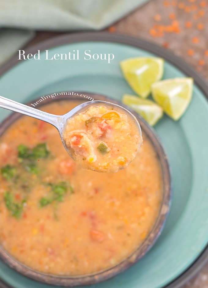 Overhead View of a Spoon Filled with pressure cooker red lentil soup Over a Bowl Filled with Red Lentil Soup