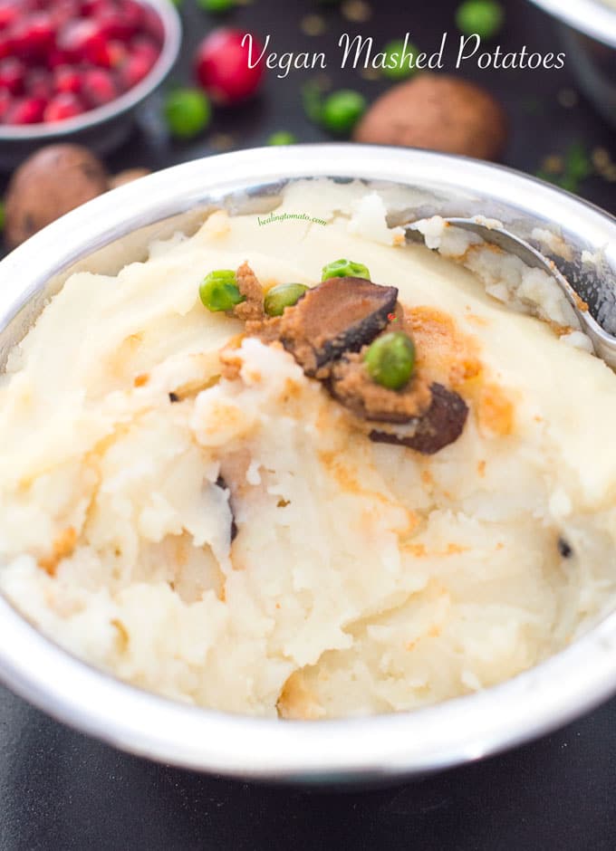 Closeup view of vegan mashed potatoes with gravy and peas in the middle