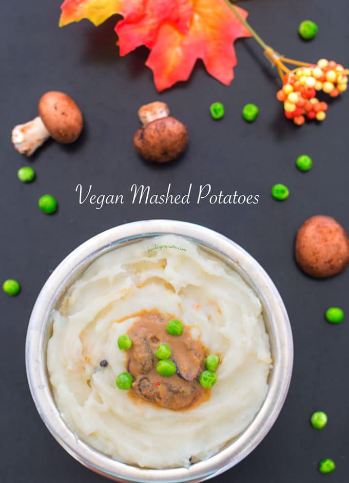 Overhead view of vegan mashed potatoes with gravy and peas in the middle
