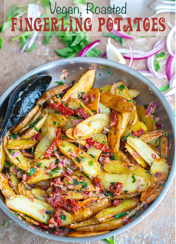 Top view of a stainless steel pan withroasted fingerling potatoes in a sun-dried tomato butter sauce