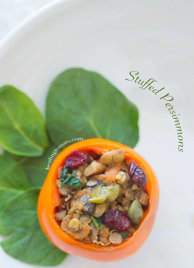 Savory Stuffed Persimmons on a white plate with spinach leaves