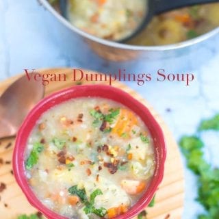 Overhead view of a red bowl with vegan dumplings soup