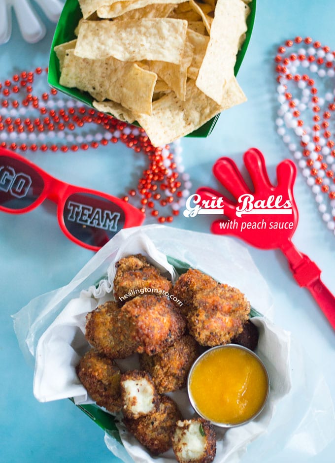 Overhead View of Fried Grits Balls In a Paper Bowl Surrounded by Sunglasses, bead necklaces and a clapper toy