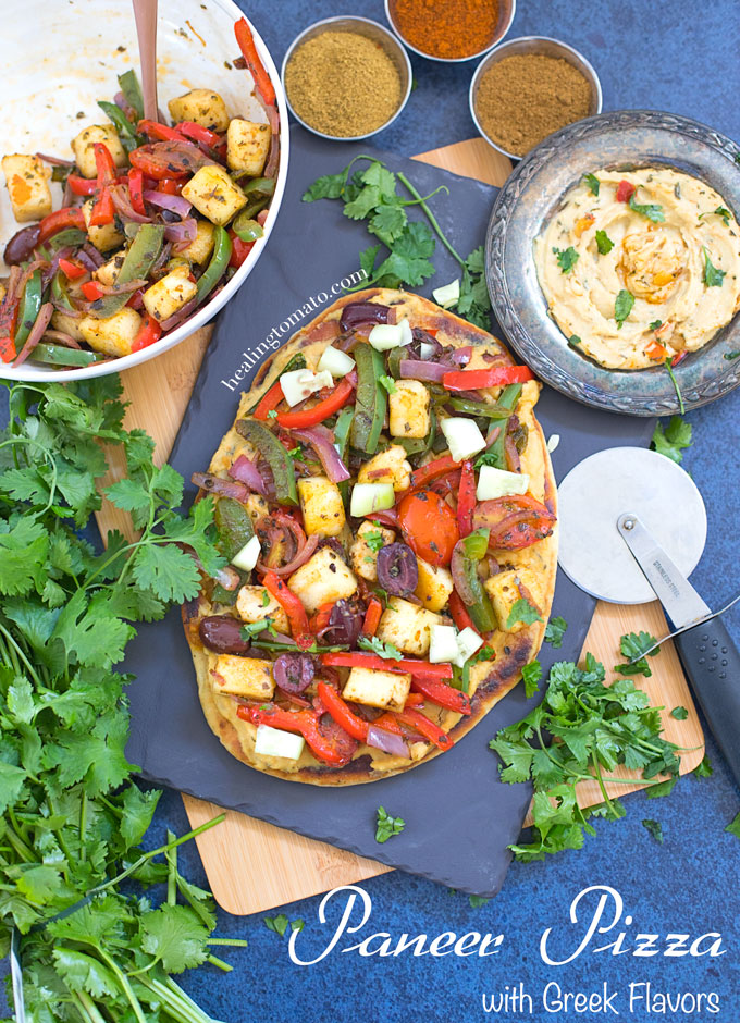 Overhead and Closeup view of Naan Paneer Pizza and surrounded by Cilantro, Hummus and spices