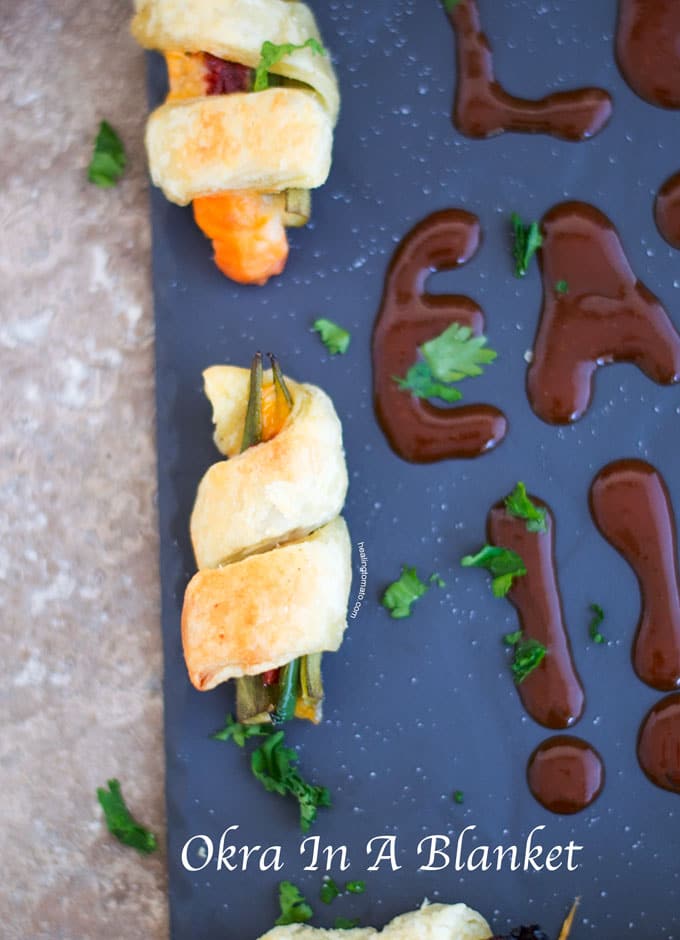 Overhead View of an Okra Wrapped with Puff Pastry and filled with Sun-dried Tomatoes, Jalapeno and Sargento Snack Bites Cheese - Okra in a blanket