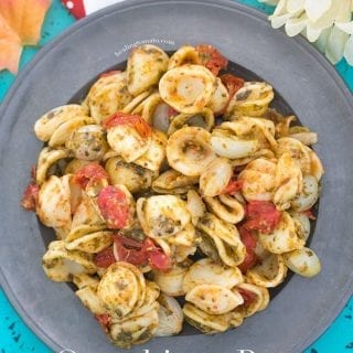 Closeup view of a grey plate filled with Vegan Orecchiette Pasta, roasted tomatoes and pearl onions