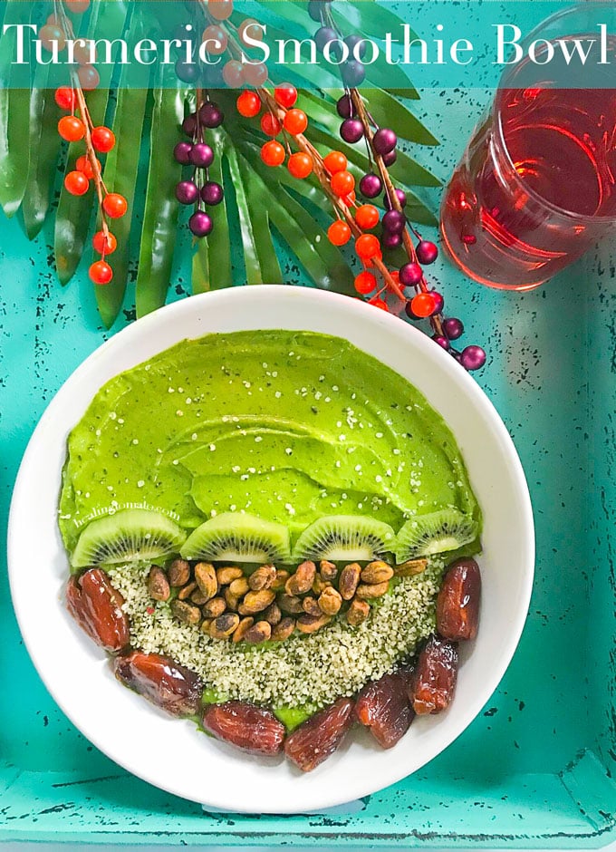 Overhead View of a Turmeric Smoothie Bowl with Green Smoothie on one half. The other half has Kiwi, Pistachios, Dates and Hemp Seeds