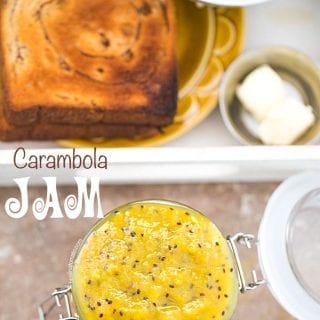 Overhead View of A Jar With Star Fruit Carambola Jam in an Open Mason Jar. A White Tray with Toast and a side of butter