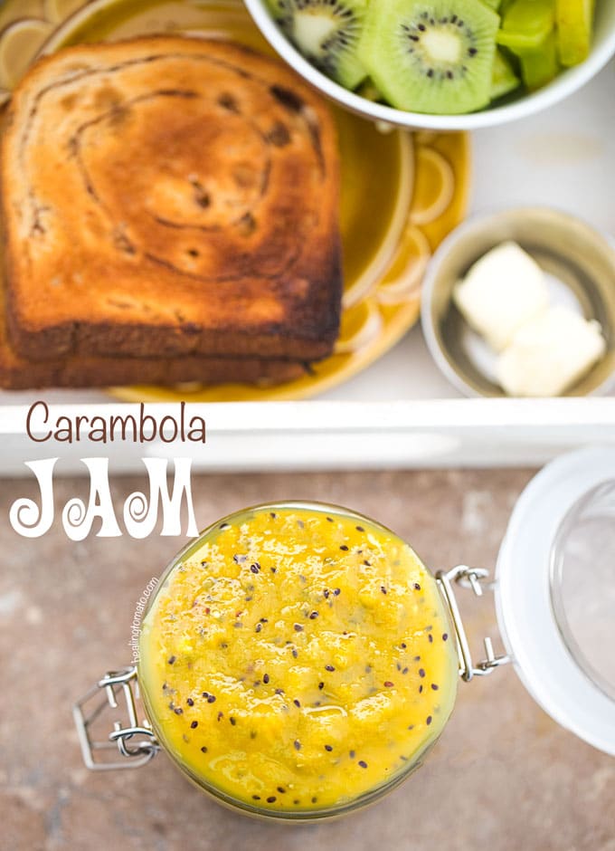 Overhead View of A Jar With Star Fruit Carambola Jam in an Open Mason Jar. A White Tray with Toast and a side of butter