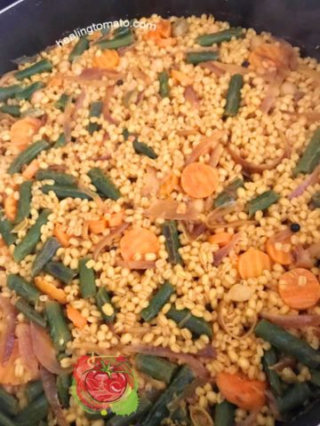Overhead view of barley pilaf completed cooking