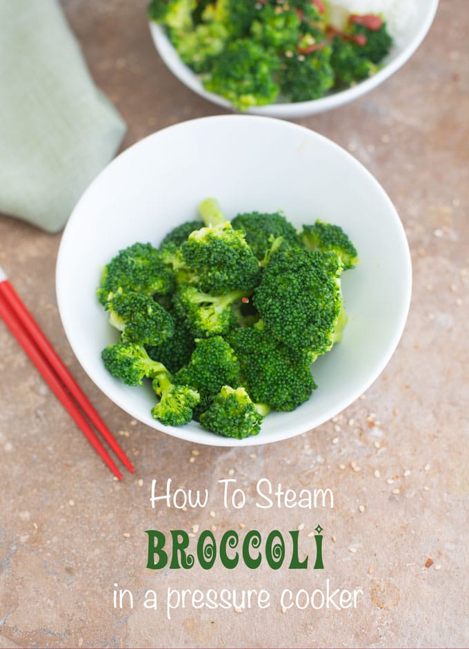 Closeup view of a white bowl of steamed broccoli with red chopsticks next to it - Pressure Cooker Steamed Broccoli