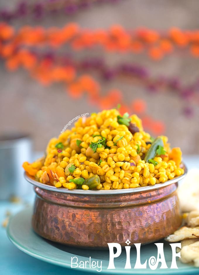 Front View of a Copper Bowl Filled to the Top with Barley Pilaf Recipe with Naan on the side