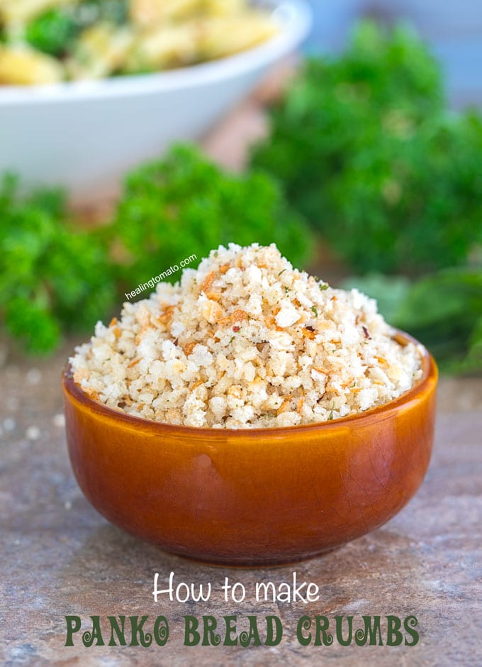 Front view of panko breadcrumbs in a small brown bowl. Fresh Parsley in the background