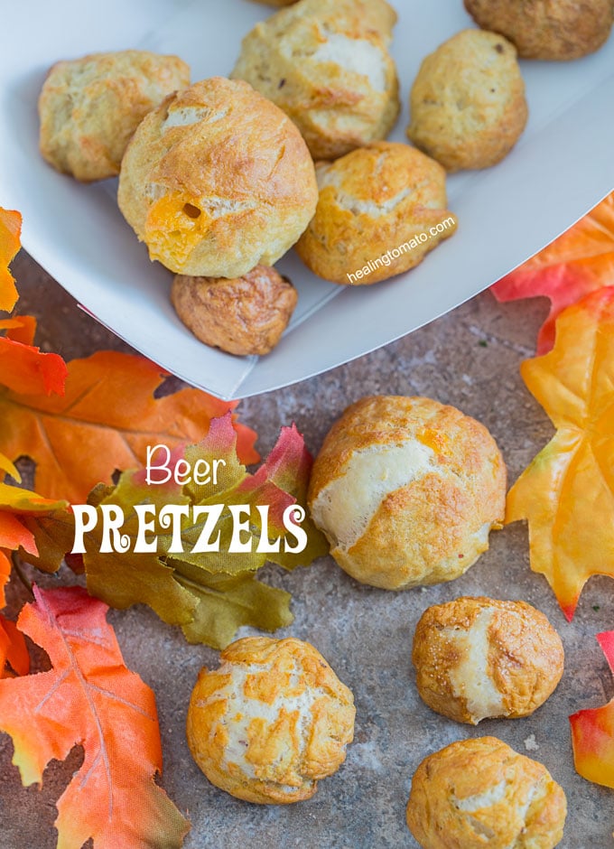 Overhead view of beer pretzel bites on a brown surface surrounded by fall leaves