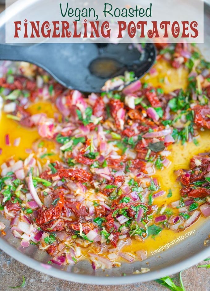 Overhead view of a stainless steel pan filled with vegan butter sauce with oregano, sun-dried tomatoes and red onions