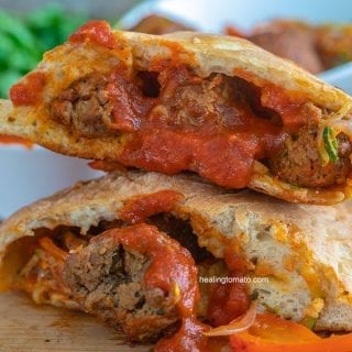 Front view of a calzone cut into half and stacked.