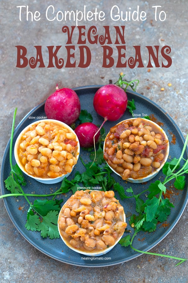 Overhead view of 3 ramekins filled with baked beans.  The ramekins are on a black plate and surrounded by cilantro and radishes
