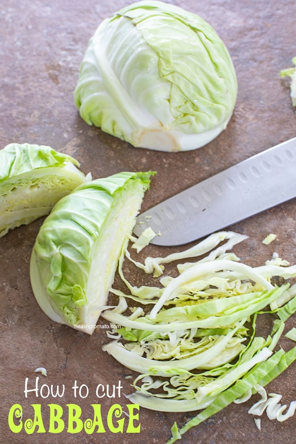 Cabbage partially cut into long, thin strips with a sontoku knife next to it - How to cut cabbage