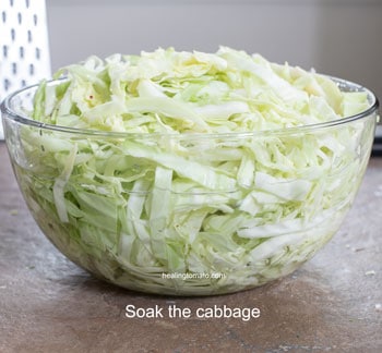 cabbage cut into thin strips and soaking in a glass bowl filled with water - Cabbage Curry