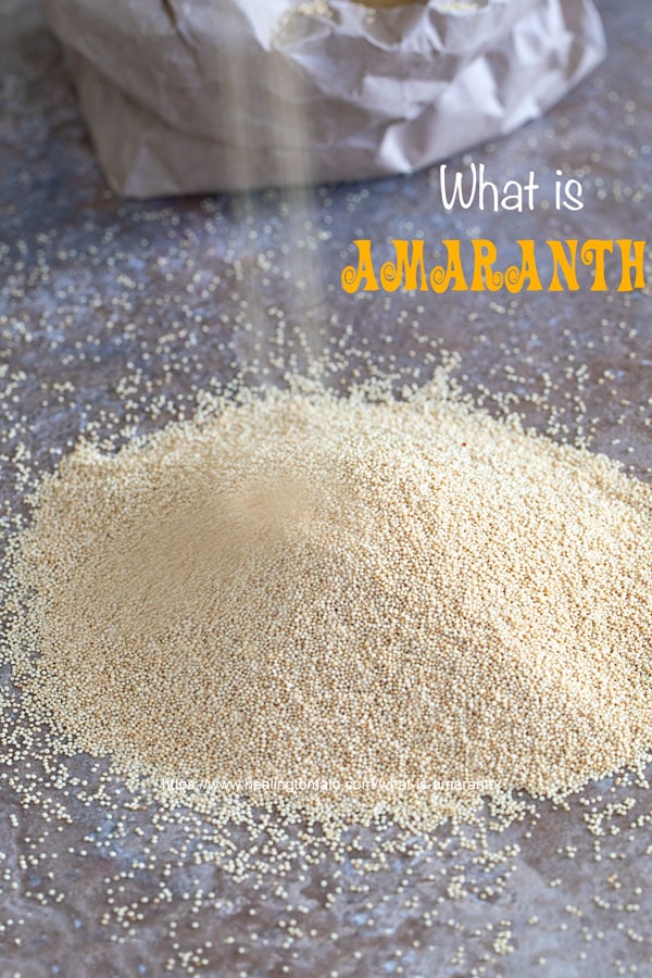 A mound of amaranth grain with more grain being poured over it