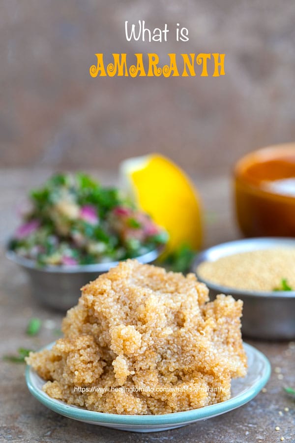 Front view of cooked amaranth on a small plate with amaranth salad in the back. Salt bowl and small bowl with amaranth grain in the background