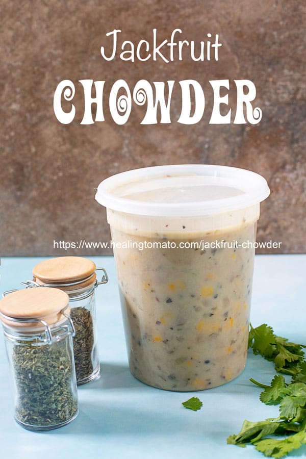 A long, clear plastic container filled with jackfruit chowder with small spice jars and cilantro next to it