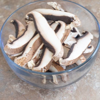 Portobello Mushrooms sliced in a bowl - Vegan Taquitos