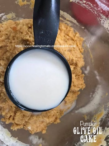 Almond milk being poured into the bowl- Vegan Pumpkin Olive Oil Cake