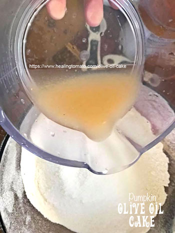 Fresh Orange Juice being poured into the flour bowl- Vegan Pumpkin Olive Oil Cake