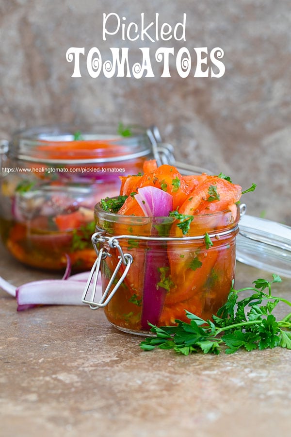 Front view of Pickled tomatoes in a mason jar and another jar in the background - preserving tomatoes