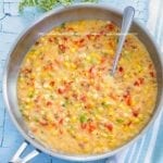 Creamed corn in a pan on a blue surface - how to make creamed corn