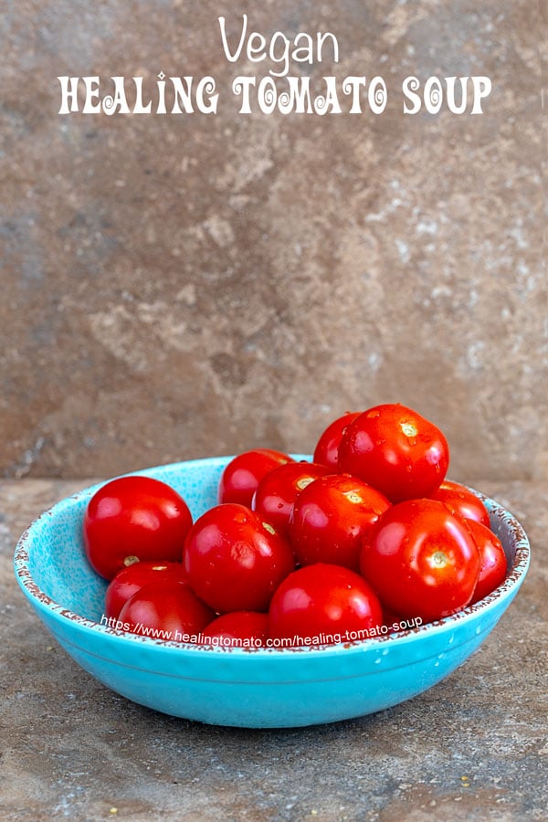 A blue bowl filled with whole campari tomatoes - Healing Tomato Soup