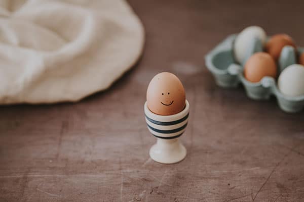 An egg in a cup with a smily face - What Vegans Don't Eat