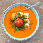 Overhead view of a blue bowl with healing tomato soup